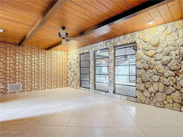 tiled spare room featuring ceiling fan, beam ceiling, and wood ceiling