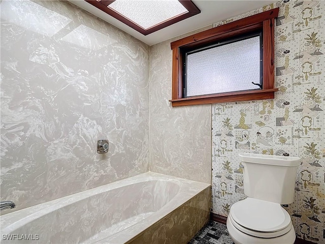 bathroom featuring a bathtub and toilet