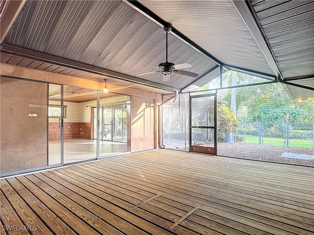 unfurnished sunroom with ceiling fan and vaulted ceiling