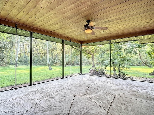 unfurnished sunroom with ceiling fan and wood ceiling