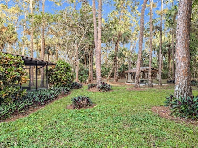 view of yard with a gazebo and a sunroom