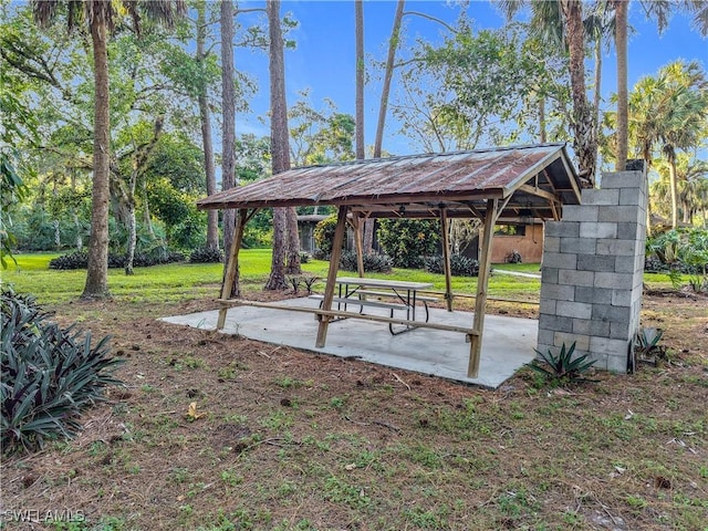 view of community with a gazebo, a patio, and a lawn