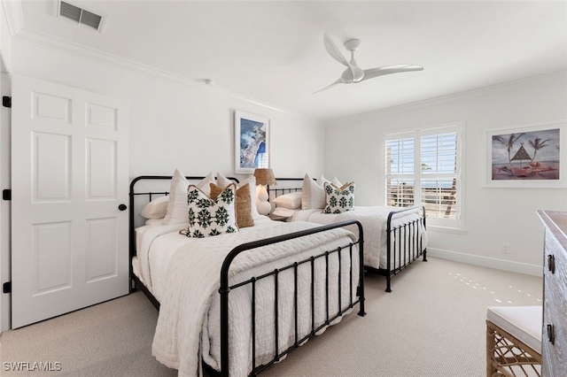 carpeted bedroom with ceiling fan and crown molding