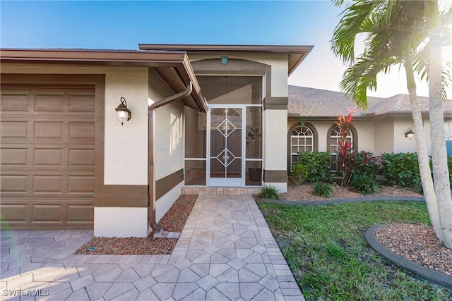 view of exterior entry featuring a garage