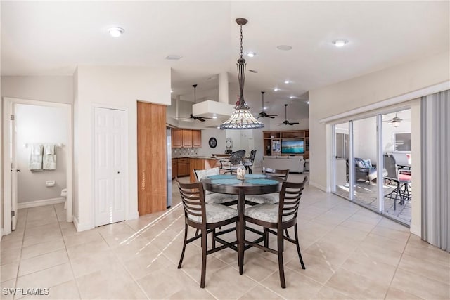 tiled dining room with lofted ceiling and ceiling fan