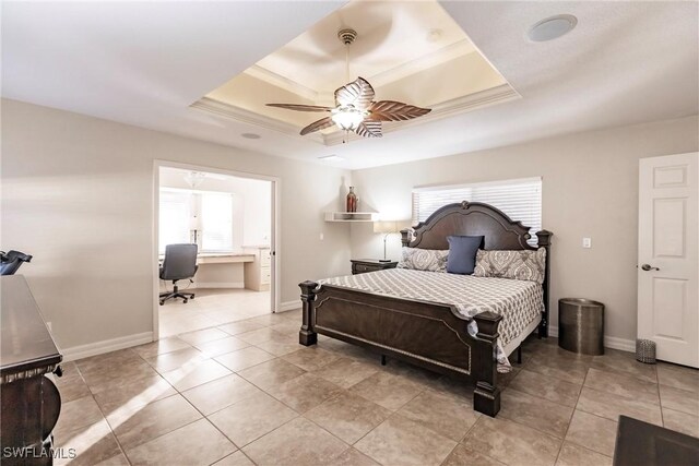 bedroom featuring connected bathroom, a raised ceiling, ceiling fan, and light tile patterned flooring