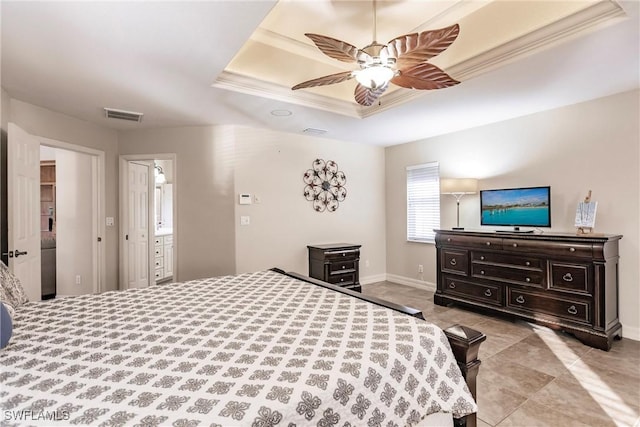 bedroom featuring light tile patterned floors, a tray ceiling, ornamental molding, and ceiling fan