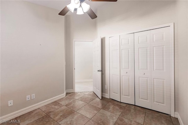 unfurnished bedroom with a closet, ceiling fan, and light tile patterned flooring