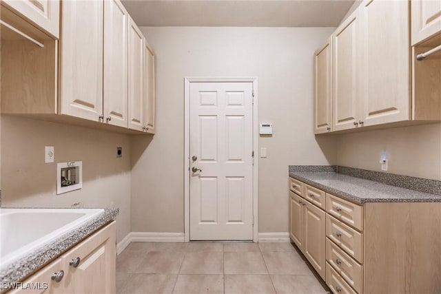 laundry room featuring light tile patterned flooring, cabinets, washer hookup, and electric dryer hookup