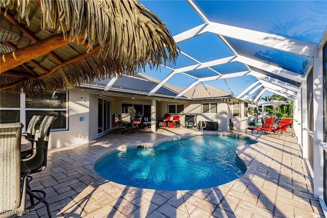 view of pool featuring a lanai and a patio area