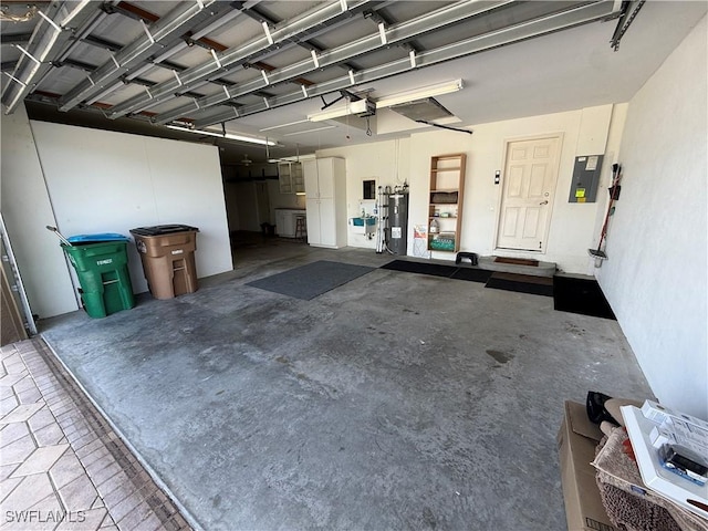 garage with a garage door opener, electric panel, and electric water heater