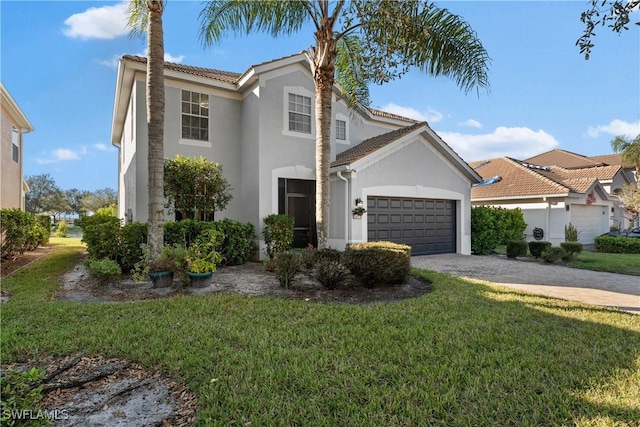 view of front of house with a front yard and a garage