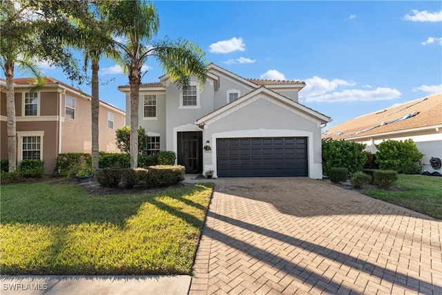 mediterranean / spanish house with a garage and a front lawn