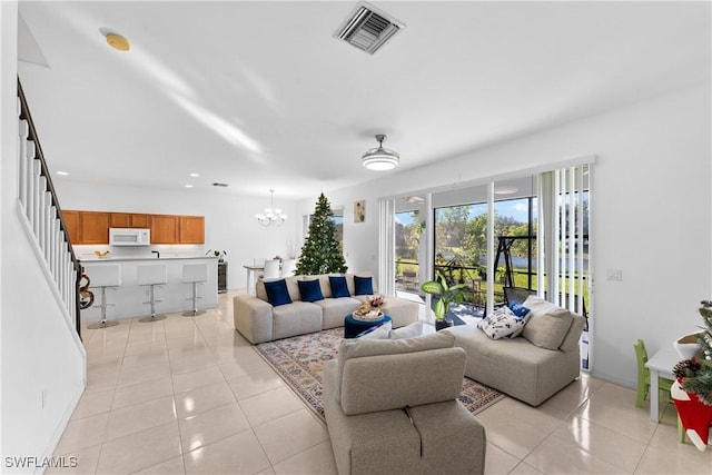 tiled living room with an inviting chandelier