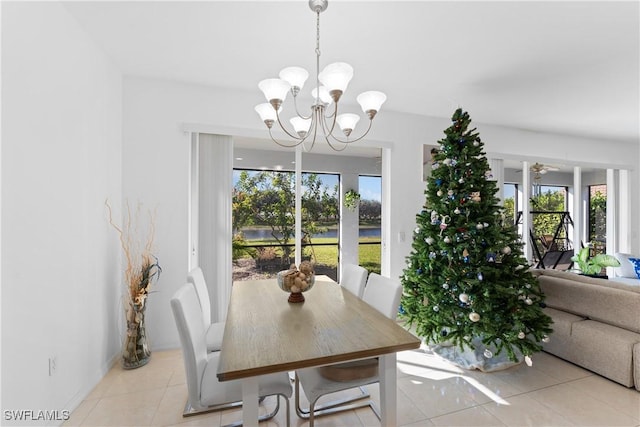 dining room featuring light tile patterned floors and ceiling fan with notable chandelier