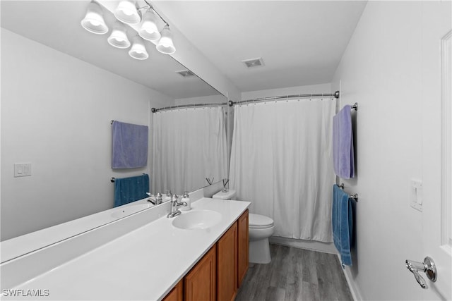 bathroom featuring hardwood / wood-style floors, vanity, and toilet