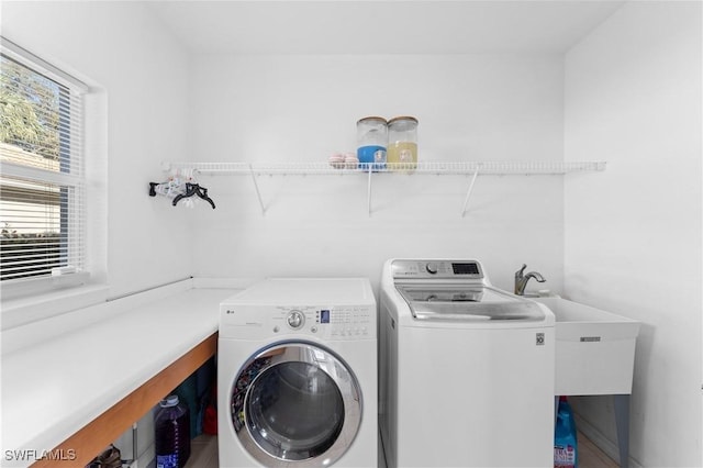 clothes washing area with sink and washing machine and clothes dryer