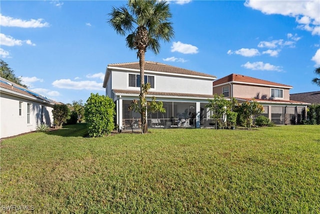 rear view of property featuring a yard