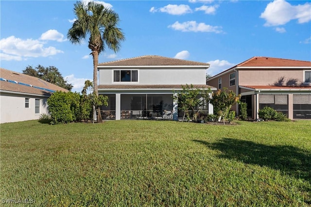 back of property featuring a lawn