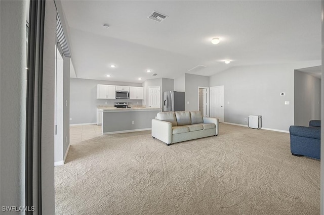 unfurnished living room featuring light colored carpet and lofted ceiling