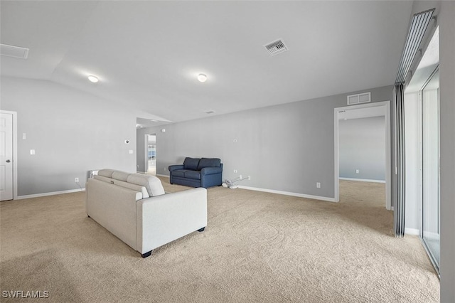 living room featuring light carpet and vaulted ceiling