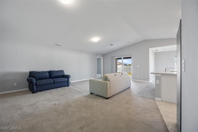 living room featuring sink, light colored carpet, and vaulted ceiling