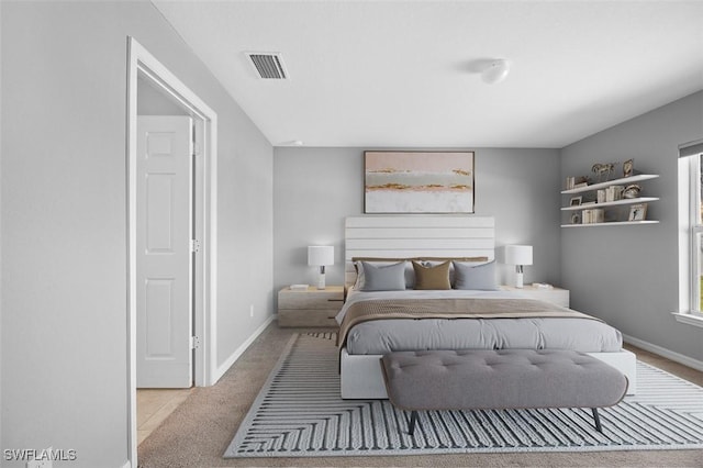 bedroom featuring light colored carpet