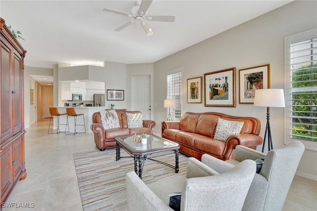 living room with a wealth of natural light and ceiling fan