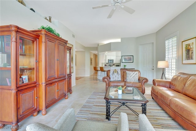 living room featuring ceiling fan and light tile patterned floors