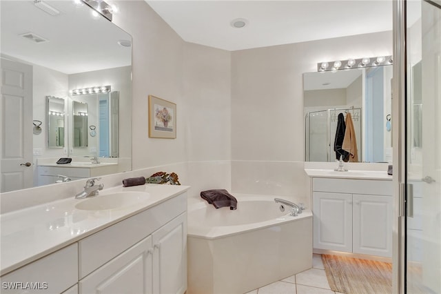 bathroom with tile patterned floors, separate shower and tub, and vanity