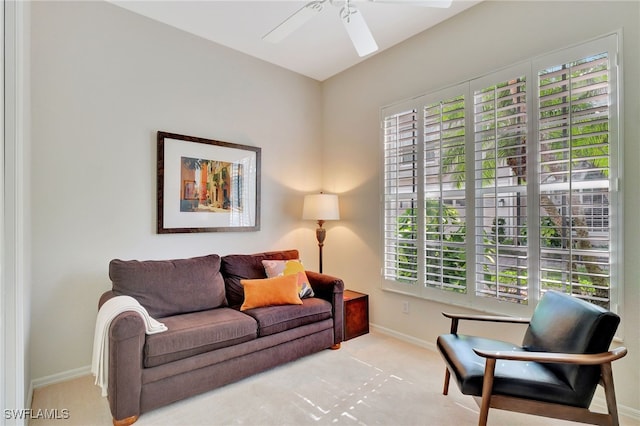 carpeted living room with ceiling fan