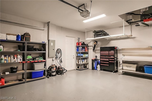 garage featuring electric panel and a garage door opener