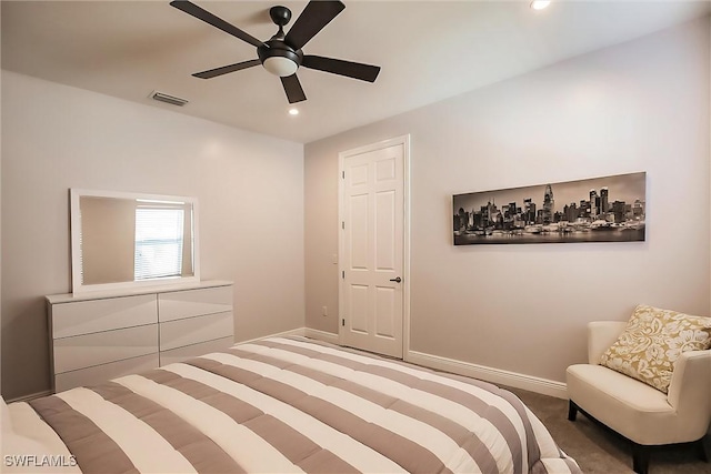 bedroom with ceiling fan and dark carpet