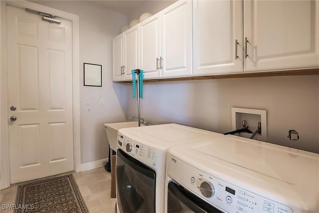 laundry area with cabinets and separate washer and dryer