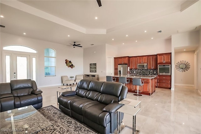 tiled living room with ceiling fan