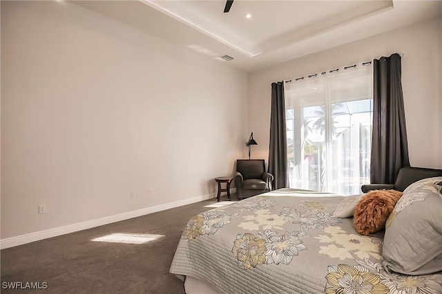 bedroom featuring ceiling fan and dark carpet