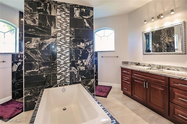 bathroom with tile patterned floors, vanity, and shower with separate bathtub