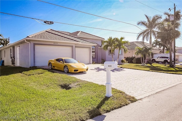 view of front of property with a garage and a front yard