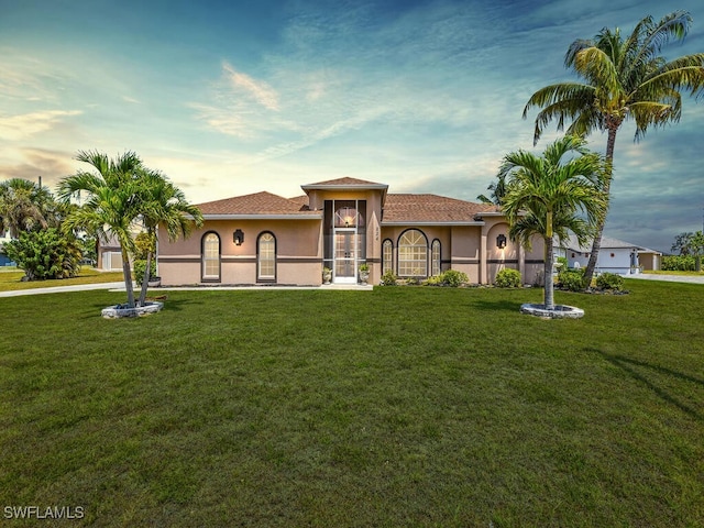 834 Santa Barbara Blvd, Cape Coral, FL 33991 - mediterranean / spanish home featuring a yard