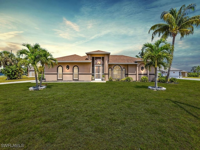 mediterranean / spanish home featuring a yard