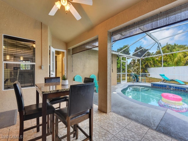 view of swimming pool with a jacuzzi, a patio, ceiling fan, and a lanai