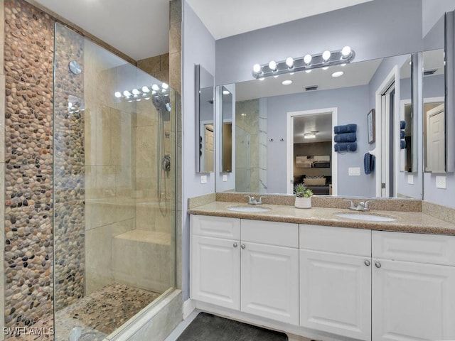 bathroom featuring vanity and a shower with shower door