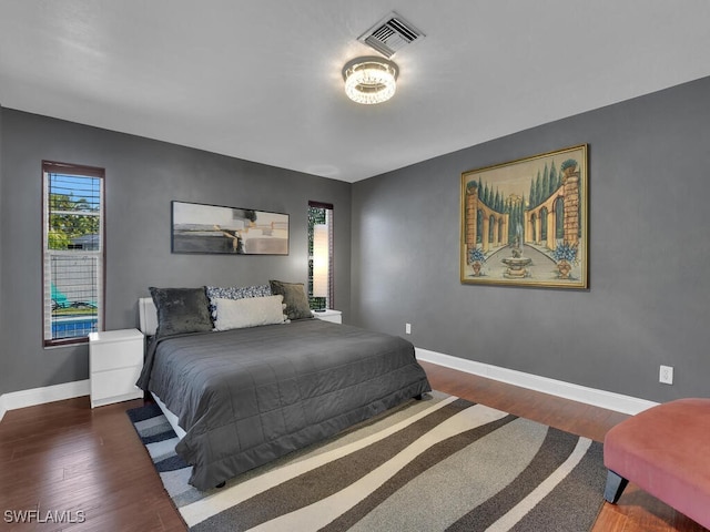 bedroom with dark hardwood / wood-style flooring