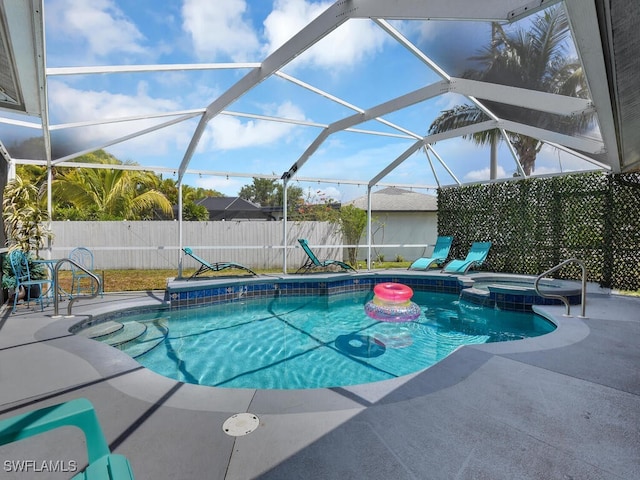 view of pool featuring a patio area, a lanai, and an in ground hot tub