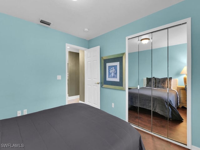 bedroom with hardwood / wood-style flooring and a closet