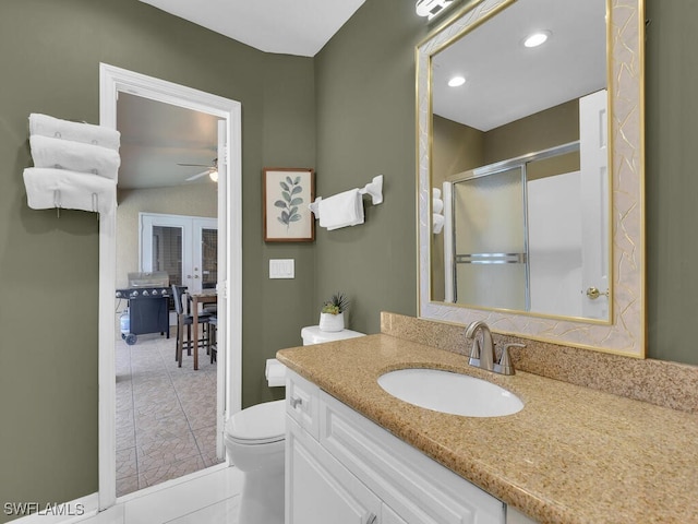 bathroom featuring vanity, french doors, tile patterned floors, toilet, and walk in shower