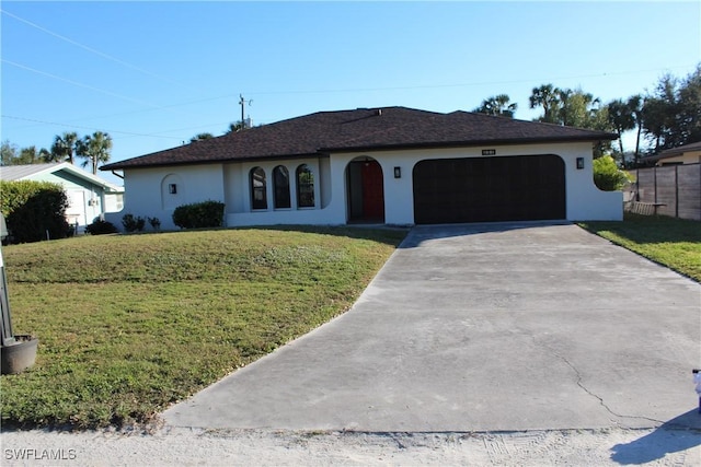 ranch-style home with a garage and a front lawn