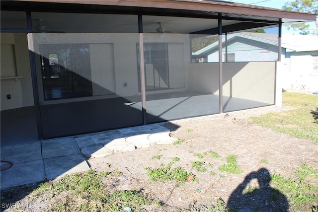 exterior space with a sunroom and a patio