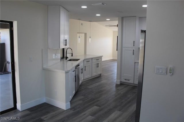 kitchen featuring white cabinetry, sink, ceiling fan, dark hardwood / wood-style flooring, and stainless steel dishwasher