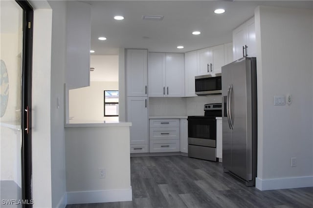 kitchen featuring white cabinetry, stainless steel appliances, and dark wood-type flooring